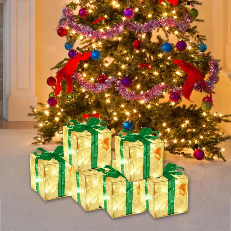 LED Christmas box ornaments arranged under a decorated tree with twinkling lights and colourful baubles