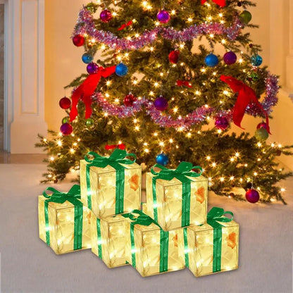 LED Christmas box ornaments arranged under a decorated tree with twinkling lights and colourful baubles