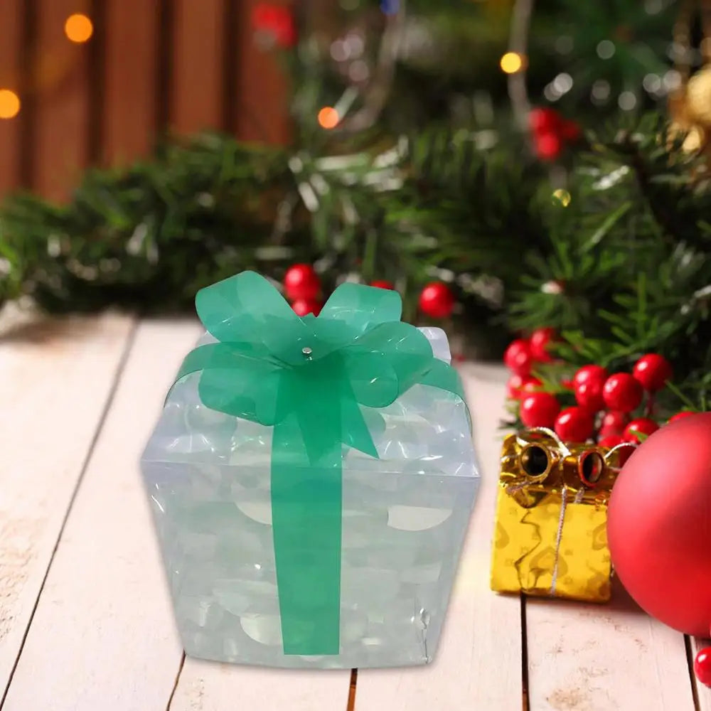 LED Christmas box ornaments with a green ribbon on a festive holiday backdrop