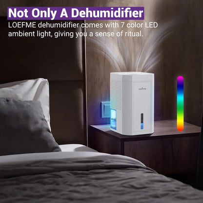 Loeffme electric home dehumidifier with 7 colour LED ambient light on a bedside table