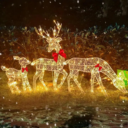 Outdoor glowing elk Christmas ornament featuring three illuminated moose with bows for festive decorations
