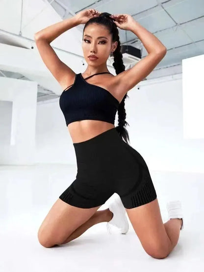Woman wearing black Butt Lift Fitness Shorts and black crop top posing indoors for fitness photoshoot