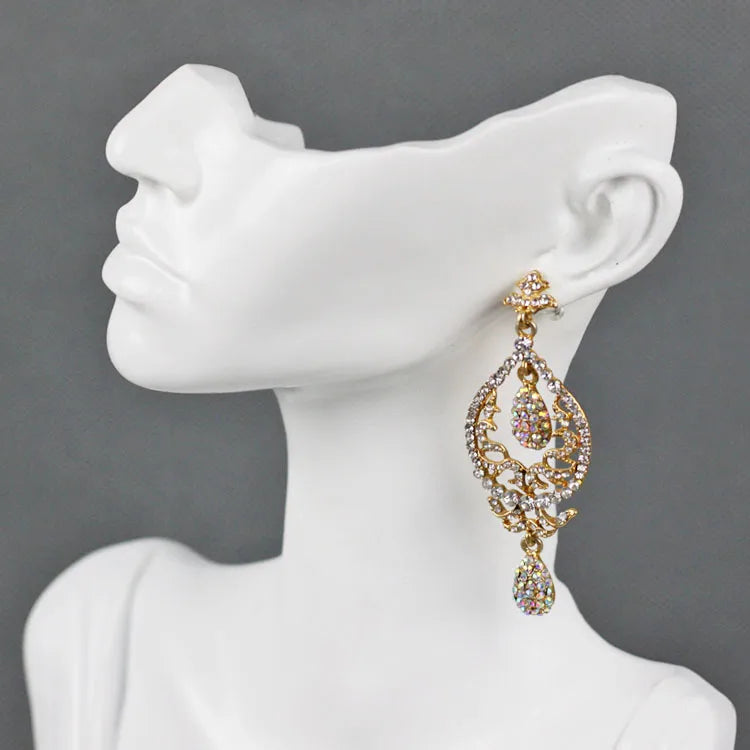 Elegant resin jewellery display stand showcasing a stunning pair of gold and crystal drop earrings