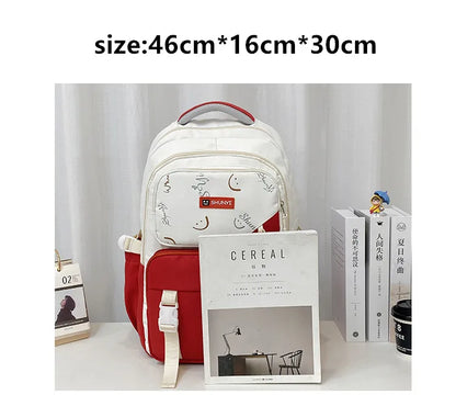 White and red backpack with smiley doodle and front pocket primary school backpack for girls 46 by 16 by 30 cm