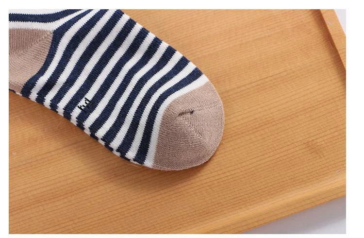 Navy and white striped soft toddler socks for boys and girls with a comfortable fit on a wooden surface