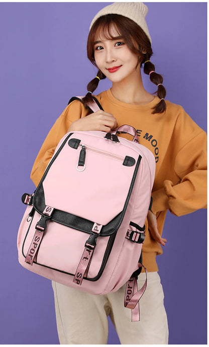 Young woman model holding Pink Black Laptop Backpack For Students pink bag with black trim front pockets adjustable straps