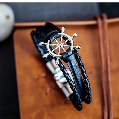 Vintage braided leather charm bracelet with silver nautical steering wheel design