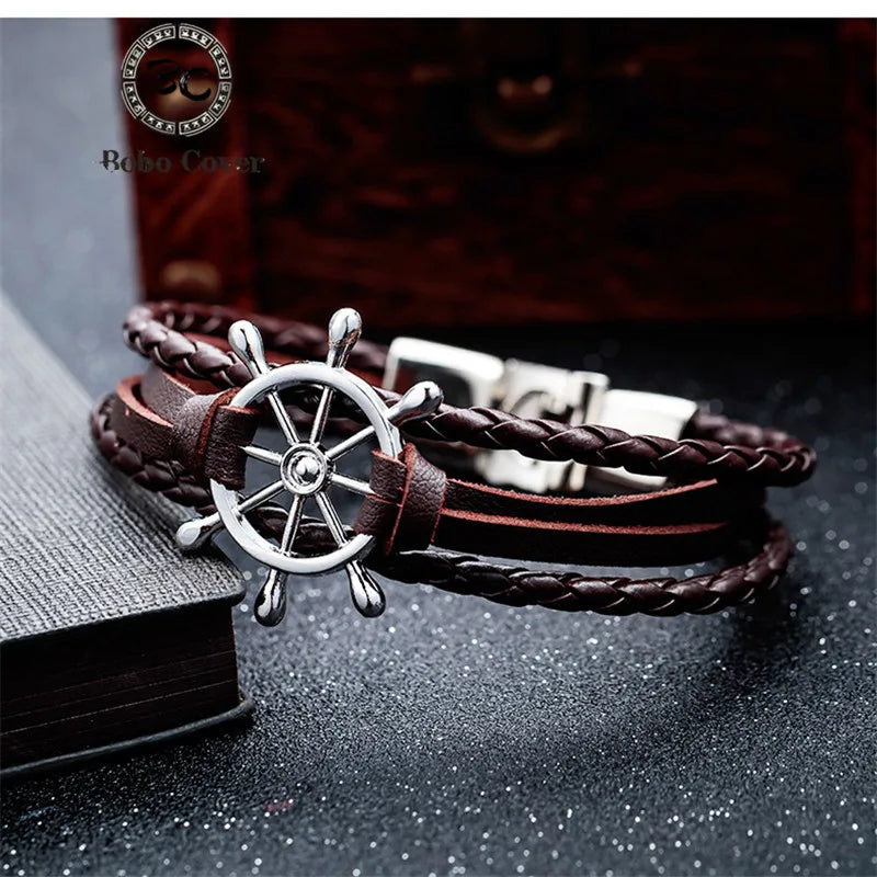 Stylish vintage braided leather charm bracelet with a silver steering wheel design and adjustable clasp